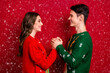 © deagreez - Profile photo of two idyllic peaceful lovers hold arms look each other eyes isolated on red color background