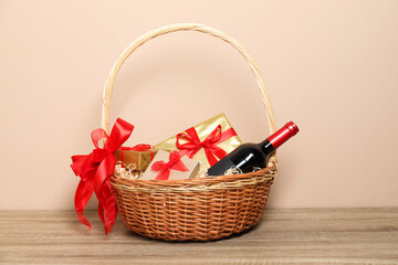 Sticker - Wicker gift basket with wine on wooden table