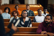 © Zamrznuti tonovi - Group of people sitting in church pews listening to sermon