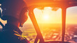 © Nakarin - pilot wearing helmet looks out of helicopter cockpit at stunning sunset, capturing essence of aviation and adventure. warm glow of sun enhances scenes beauty and excitement