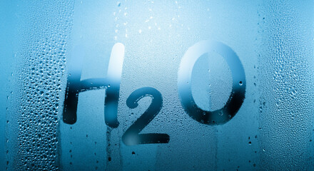 Poster - Water droplets on glass with condensation highlighting H2O symbol and blue backdrop