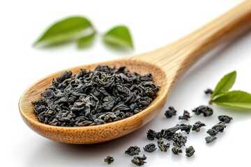 A spoonful of black tea leaves is shown on a white background