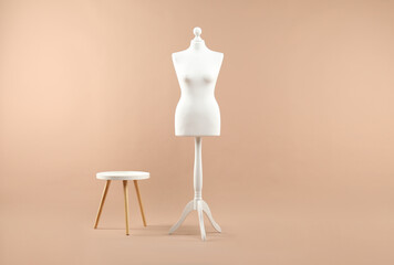 Canvas Print - Female mannequin and stool on beige background