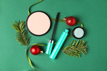 Wall Mural - Flat lay composition with makeup products and Christmas decor on green background