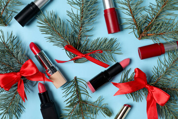 Wall Mural - Lipsticks and Christmas decor on light blue background, flat lay