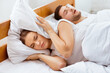 © Prostock-studio - Snoring. Unhappy Girlfriend Trying To Sleep Near Snorting Boyfriend In Bed Indoor. Selective Focus