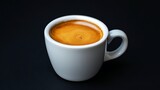 A white cup of espresso on a black background.