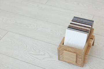 Canvas Print - Different samples of wooden flooring in crate indoors, space for text