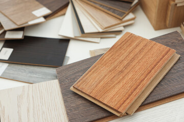 Poster - Different samples of wooden flooring on white table, closeup