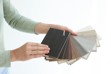 Poster - Woman with samples of wooden flooring indoors, closeup