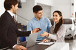© Prostock-studio - Car Sales. Manager Giving New Auto Key To Happy Couple Buying New Vehicle Standing In Dealership Shop