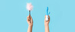 © Pixel-Shot - Female hands with vibrator and feather stick from sex shop on color background