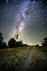Wall Mural - Space with galaxy . Milky way on the blue sky .Dark and cold night at summer . Trees on the backgound with stars . Power lines in the night , powerstation and galaxy