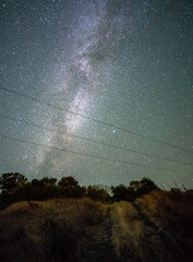 Wall Mural - Space with galaxy . Milky way on the blue sky .Dark and cold night at summer . Trees on the backgound with stars . Power lines in the night , powerstation and galaxy