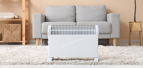 Canvas Print - Electric convector heater in living room. Concept of heating season