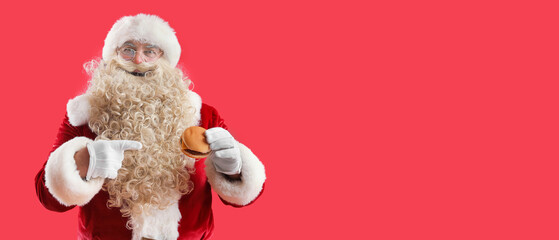 Sticker - Santa Claus pointing at tasty burger on red background