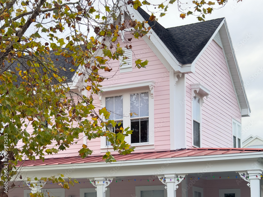 The exterior corner of a house with pale pink wooden clapboard siding ...