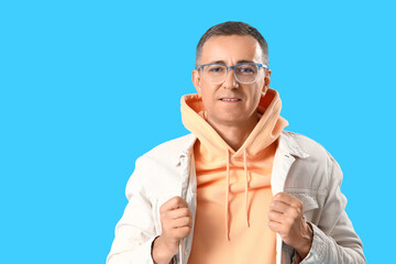 Poster - Mature man in eyeglasses on blue background