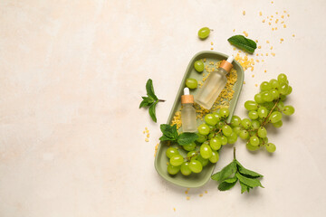 Wall Mural - Bottles with cosmetic oil, sea salt and grapes on white background