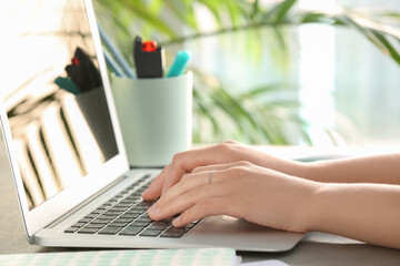 Poster - Woman using modern laptop at table in office