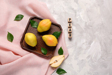 Word PEAR and tray with fresh fruits on grey background