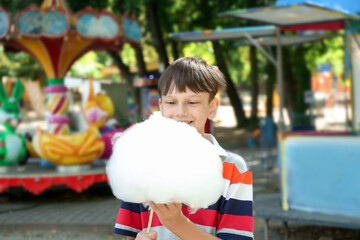 Sticker - Portrait of little boy eating sweet cotton candy in park