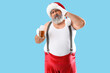 © Pixel-Shot - Bad Santa Claus with beer on blue background