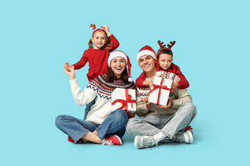 Sticker - Happy family in warm sweaters with Christmas gifts on blue background