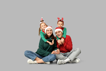 Poster - Happy family in Christmas clothes on grey background