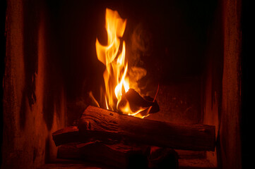 Home fireplace with red flame fire burns