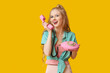 © Pixel-Shot - Beautiful young happy woman with retro telephone on yellow background