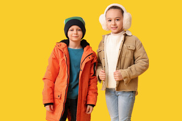 Sticker - Cute little happy children in warm winter clothes on yellow background