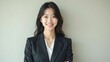© Yuudaishin - Asian Businesswoman Smiling in Formal Suit