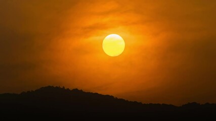Wall Mural - time lapse of dramatic sunrise with orange sky in a cloudy day.