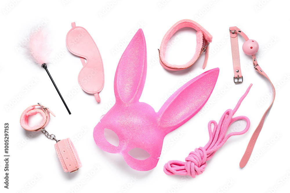 Pink bunny mask with sex toys on white background Stock Photo  
