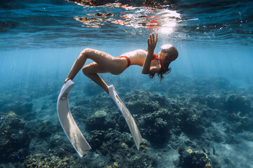 Wall Mural - Woman with sexy body swimming in blue sea. Snorkeling with sexy girl