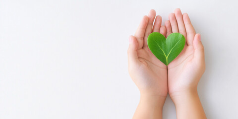 tiny heart shaped green leaf is gently cradled in two hands, symbolizing care and love for nature. t