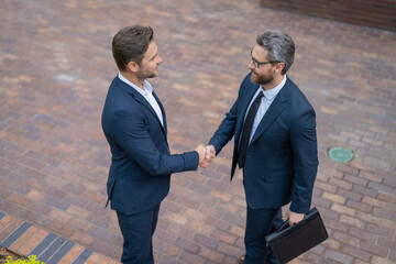 Businessmen handshaking after contract deal. Successful agreement in business deal. Businessmen dealing. Partnership concept. Handshaking. Business partnership. Business deal. Partnership success