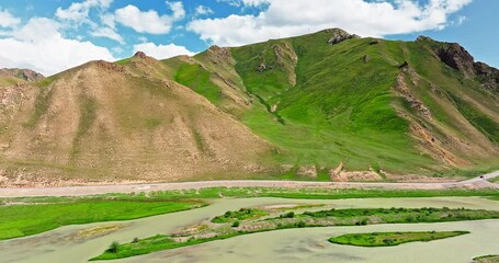 Wall Mural - Green grassland and curved river with mountain natural landscape in Xinjiang. Famous grassland pasture scenery in China.