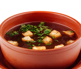 Delicious soup with croutons and herbs served in brown bowl