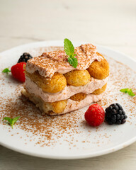 Wall Mural - Italian tiramisu with red berry cream. Top view table with  decorations.