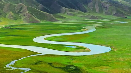 Sticker - Green grassland and curved river natural landscape in Xinjiang. Famous grassland pasture scenery in China.