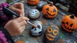 © Witch - Child Painting Halloween-Themed Rocks with a Brush