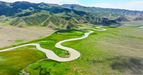 Wall Mural - Green grassland and curved river with mountain natural landscape in Xinjiang. Famous grassland pasture scenery in China.