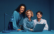 © Jacob Lund - Diverse group of co-workers posing in a studio shot smiling with laptop and smartphone