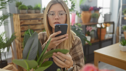 Sticker - Young woman taking photo with smartphone in lush flower shop