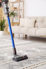 Canvas Print - Cleaning with wireless handheld vacuum cleaner indoors, closeup