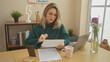 © Krakenimages.com - Blonde woman reading document at home office with laptop and coffee on desk