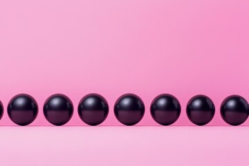 Poster - A cluster of black orbs lying on a magenta background beside a line of monochromatic spheres