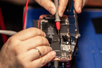 Aufkleber - Repairing a smartphone battery with precision tools to ensure optimal performance during a busy afternoon at a tech repair shop
